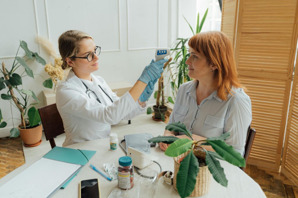 Doctor conducting health checkup with patient at home, enhancing healthcare accessibility.