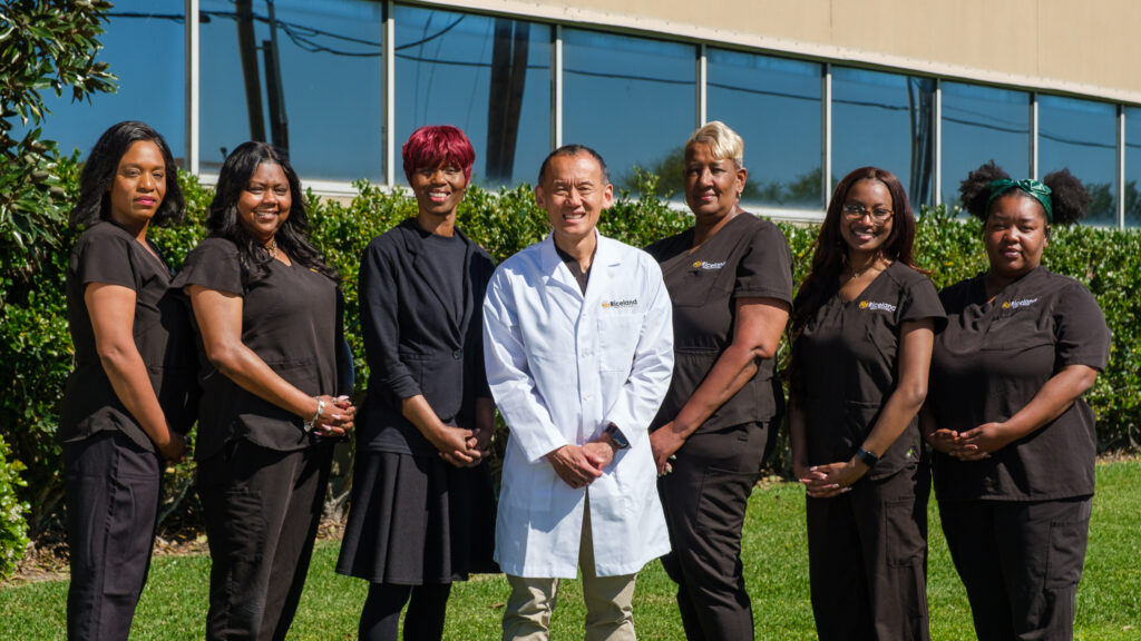 Medical team standing outside clinic.